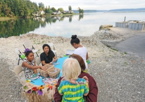 Tai Mamea, middle, who does accounting work at Minterbrook Oyster Farm, and her two daughters Kiki, right, and Malaysia greeted guests of the KP Farm Tour with candy leis Saturday.